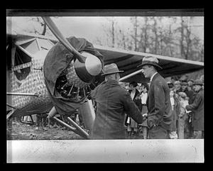 Charles Lindbergh speaking to someone in front of his plane, "Spirit of St. Louis"