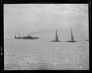 Mayflower escorted by a coast guard cutter, yachts in foreground