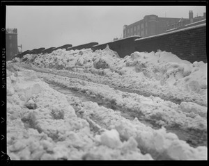 Snow piled high against wall