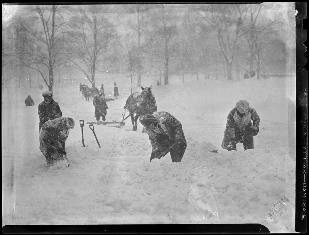 Workmen shovel snow