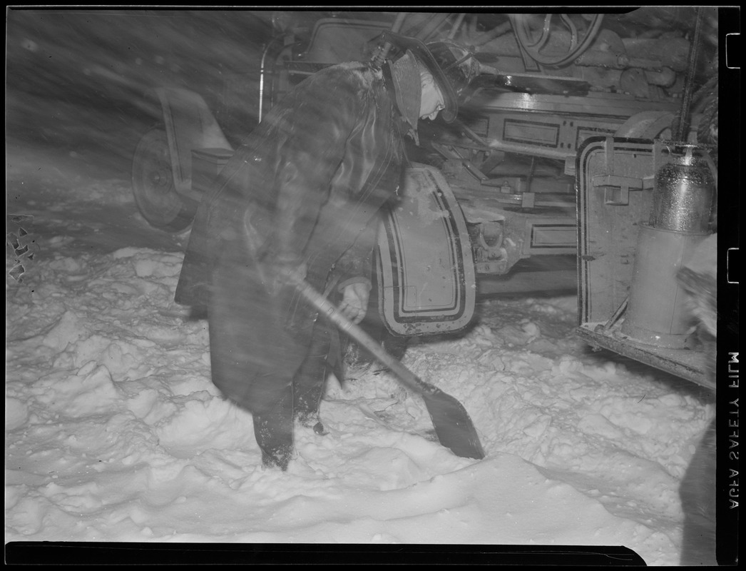 Fireman digging out fire truck, Valentine's Day storm