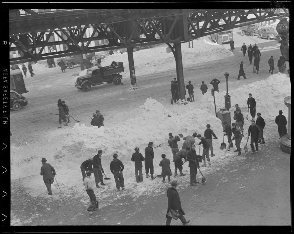 Crew removes snow from under the elevated