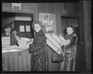 Ladies deliver package at South Station postal annex during Christmas rush