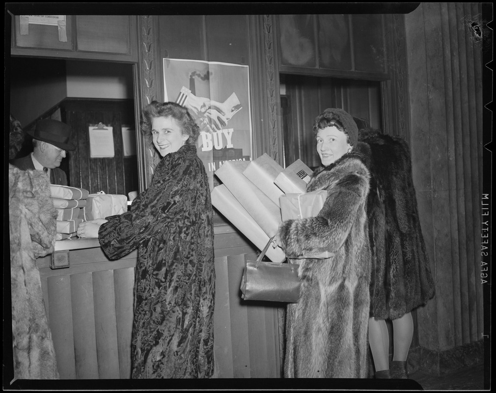 Ladies deliver package at South Station postal annex during Christmas rush