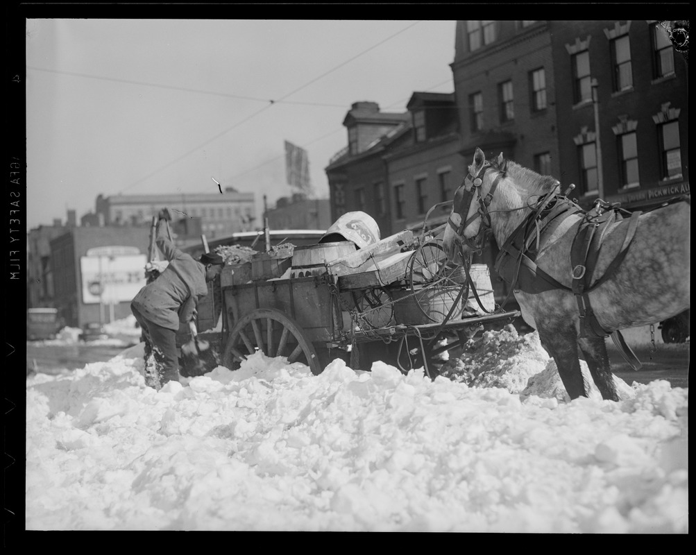 Colored man digging out horse and cart