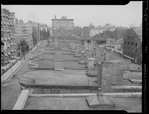 View from rooftops on Newbury Street off Kenmore Square. Fenway Studios in distance to right along B&A Railroad tracks beyond Charlesgate overpass.