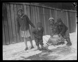 Black kids bringing coal home on sled, South End