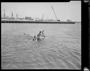 Boys swimming in harbor
