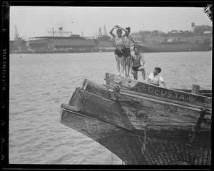 Boys posing on wrecked bow of the "Augusta W."