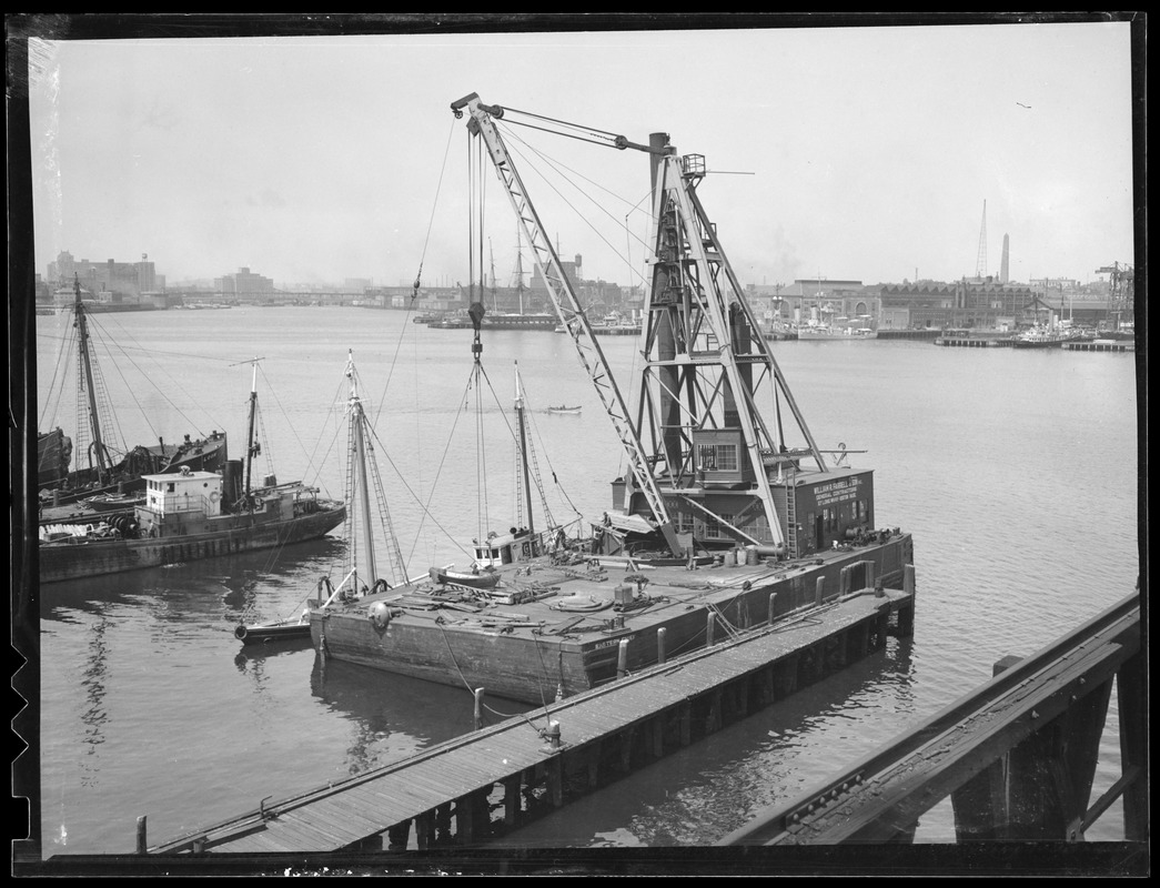 Farrell & Son floating Derrick moored at East Boston , with view of Charlestown