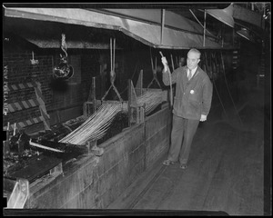 Charlestown Navy Yard/rope making, head man, Charles Leary, employed for 39 years in the rope walk - watching the threads passing through the tar trough.