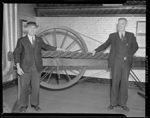 Charlestown Navy Yard/rope making, T.J. Kaes (with hat) foreman of rope making crew and oldest employee at Navy Yard started at age 15 in 1898 working with his hand spinner, has worked for 41 years. F. B. Christensen - quarter man - also started in 1898, have worked together for all of 41 years except for one month.