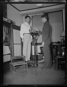 Physical testing, man getting weighed on a scale