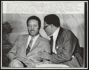 The president of the Southern Christian Leadership Conference, Rev. Ralph Abernathy (L) gets a briefing from his North Carolina coordinator, Golden Frinks, during a visit here last night. Abernathy, who was scheduled to lead a protest march in support of local Negroes in their dispute with authorities over school integration, complained of a virus infection and is scheduled to be examined by doctors in nearby Washington, N.C. later today (11/27). Speculation is that Abernathy will return to Atlanta without participating in the march.