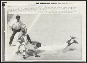 Out at Third -- New York Met right fielder Ron Swoboda slides into third as Los Angeles Dodger Jim Lefebvre reaches for the ball in fourth inning of game at New York's Shea Stadium on Sunday. Lefebvre got the ball in time for the out. Swoboda went to third on a bunt by Bud Harrelson, which was fielded by Dodger pitcher Don Sutton. Umpire Ken Burkhart called the play. Mets won, 7-4.