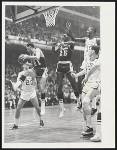 Los Angeles Lakers Jim King and Leroy Ellis leap for a rebound surrounded by Boston Celtics Larry Siegfried, John Thompson, and John Havlicek