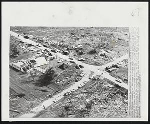 Howe, Okla. - Devastation - In 10 Seconds - This is a section of Howe, southeastern Oklahoma community of 500 where a Friday night tornado lasting only 10 second destroyed 30 homes and killed at least nine persons. At left center are the ruins of one of three churches in the twister's path. To the right of it is a tent set up for emergency persons after the storm. Four died when the tornado hit the nearby village of Reichert.
