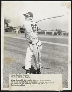 Jim Russell (above), Boston Braves outfielder completes a healthy swing in a warm up session at spring training camp at Bradenton, FLA.