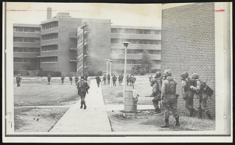 National guardsmen move toward a dormitory on the North Carolina A&T State University campus in Greensboro using tear gas to drive out snipers. Gov. Bob Scott ordered campus cleared of student rebels.