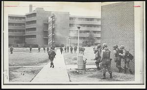 National guardsmen move toward a dormitory on the North Carolina A&T State University campus in Greensboro using tear gas to drive out snipers. Gov. Bob Scott ordered campus cleared of student rebels.