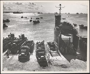 USS LSM-138 beached at Seeadler Harbor, Los Negros, Admiralty Islands Group, while loading rations, small arms ammunition, and trucks, 7 October 1944