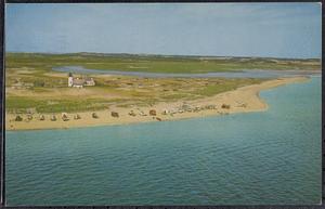 Air view of Race Point Lighthouse, showing beach buggies at shore, Provincetown, tip of Cape Cod, Mass.