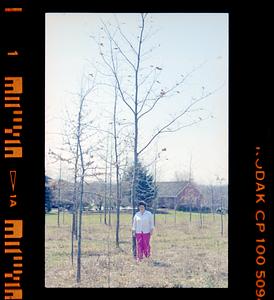 Unidentified person posing with tree