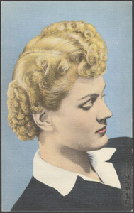 A blonde woman looking to the downwards, three-quarter profile