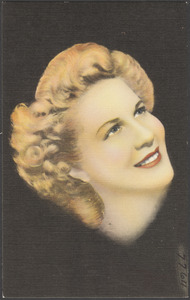 A blonde woman looking upwards, three-quarter profile