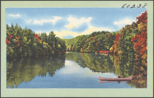 Tree-lined lake, canoe in foreground