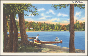 Two people in a canoe by a lake
