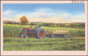 Tractor by a field of corn
