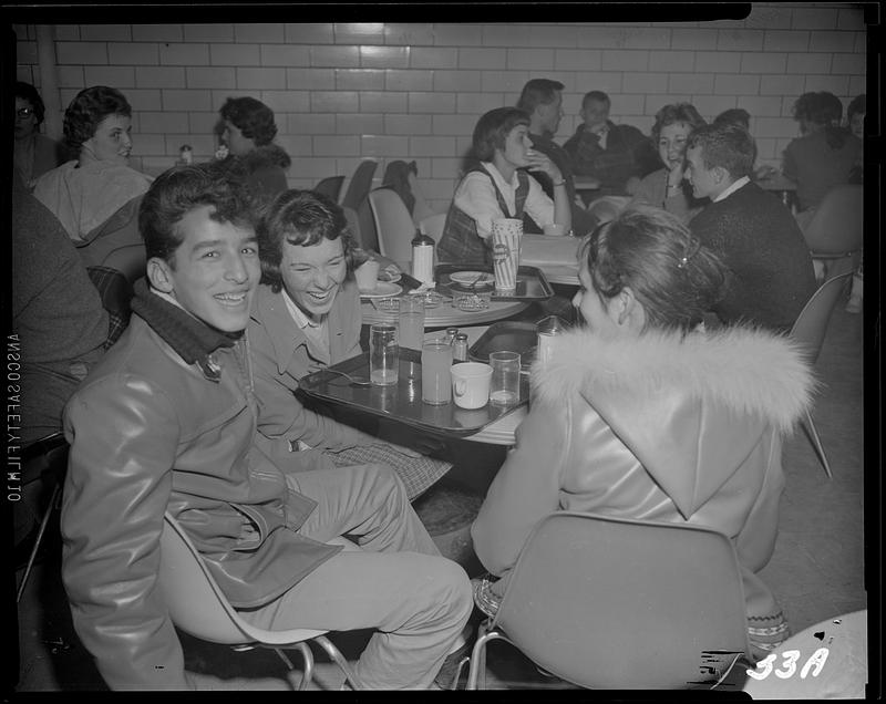 Students around a table eating and drinking