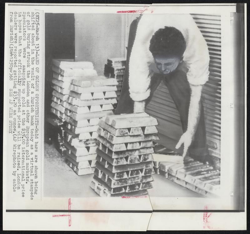 Land Of Golden Opportunists - Gold bars are shown being shifted about in the vault of a Zurich bank today as a virtual stampede of gold buying struck the London and other European gold markets. Speculators were snapping up gold at the $35.00 international price in hopes that the officially supported price will be raised. London dealers were reported getting $35.20 an ounce.