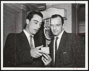 Souvenir Hunters - Reno Bertoia, left, and John Groth of Detroit Tigers look over some gift items before taking off for night game at Fenway Park. Both are expected to see a lot of action in series against Red Sox.