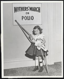 "The Little General" of the Suffolk County Mothers' March on Polio, Carolyn Tessin, 5, of Brighton, proudly points to the banner under which more than 10,000 Suffolk County women (and men too) march tonight (January 27) to collect funds, in a house-to-house canvass, for the continued care and treatment of March of Dimes patients like Carolyn. Signal to be used by residents to indicate their willingness to contribute to the polio drive between 7 and 8 p.m. will be a lighted porchlight, and, in the case of apartment and hotel dwellers, a shoe or handkerchief tied to the doorknob.