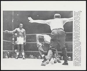 And the Fights Over-- Referee Harry Krause signals the end of the fight as an impassive Heavyweight Champion Sonny Liston stands in neutral corner and defeated challenger Floyd Patterson slowly gets to his feet. Liston retained his title by knocking out Floyd Patterson in 2 minutes 10 seconds of the first round at Las Vegas tonight.