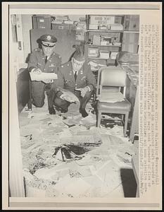 Army Reserve Officers Maj. Walter Cavanaugh (L) and Col. John Kelly (R) examine paint and ink splattered draft records at the Copley So., draft office (11/8). The FBI says that "upwards of five or six" draft boards in Boston have been burglarize and some selective service records destroyed. The Boston raids occurred (11/7) night.