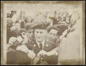 New York: Green beret reservist Gary Rader, 23, is surrounded and joined by sympathizers during draft card burning ceremony at beginning of anti-Vietnam war demonstration in central Park 4/15. Hundreds of thousands of peace demonstrators began converging on the city from many points east of the Mississippi 4/15, to stage the nation's largest rally seeking an end to fighting in Vietnam.