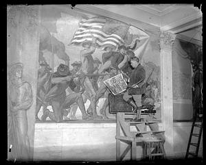 A man stands on scaffolding in front of the Spanish-American War Memorial Mural, Massachusetts State House