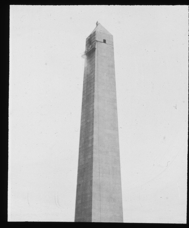 Workman on apex of monument