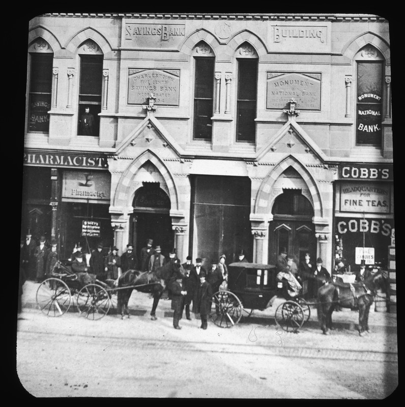 Doorways of Savings Bank Building with carriages and citizen