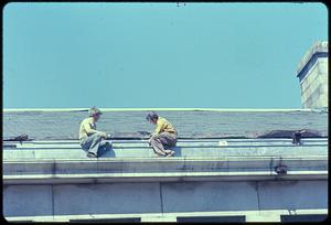 Two men working on roof