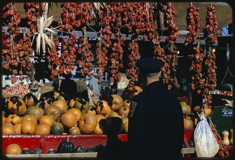 Boston policeman at produce stand, North Market, Boston