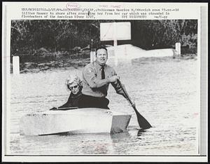Policeman Maurice H. Ottovich rows 75-yr-old Lillian Hammer to shore after rescuing her from her car which was stranded in floodwaters of the American River 1/27.