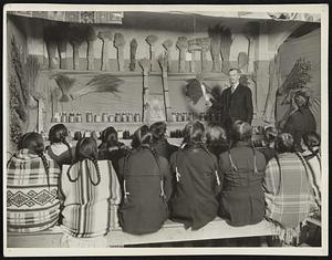 Indians listening to a lecture at the Mid-Winter Agricultural Fair, which is held annually on the Glacier National Park reservation.
