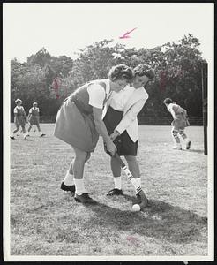 Neat Stickwork-Alison Hersey, left, gets some tips from manager-coach Jackie Westervelt at practice of U.S. field hockey squad. Miss Hersey is a graduate of Winchester High and Tufts U.