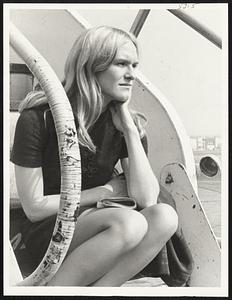 Going Nowhere in a hurry, Joan Twooney, 22, of Boston, sits on steps of plane scheduled for Syracuse, N.Y. but grounded at Logan Airport by fog.