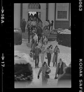 Students walking on snowy sidewalk