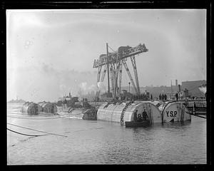 Large wooden salvage or stowage pontoons in water, Charlestown Navy Yard
